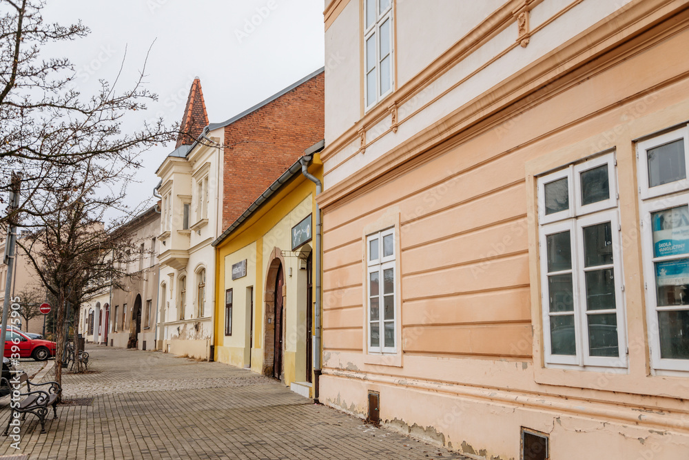 Main town Husovo Square at cloudy autumn day, picturesque street with colorful historical buildings in old historic center of Cesky Brod, Central Bohemia, Czech Republic