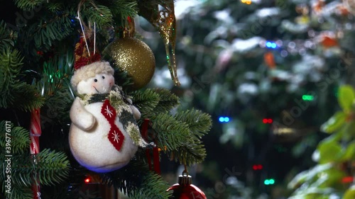 Snowman hanging on Christmas Tree, Snow falling on window