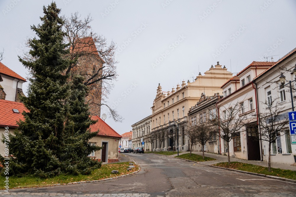 Main town at cloudy autumn day, picturesque street with colorful historical buildings in old historic center of Cesky Brod, Central Bohemia, Czech Republic