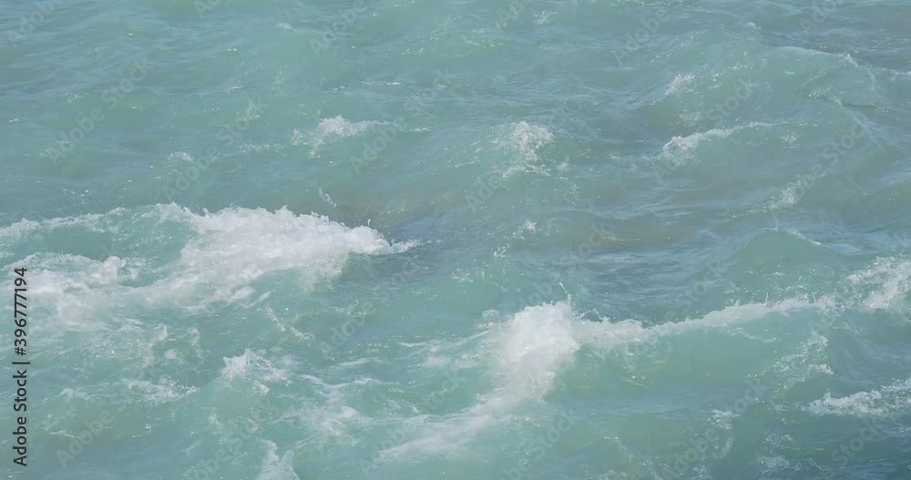 Beautiful azure waves of river Sochi, flows from Caucasian mountains. Mountain river at sunny day. Sochi, Russia. Beautiful azure waves of river Sochi, flows from Caucasian mountains. Mountain river at sunny day. Sochi, Russia.