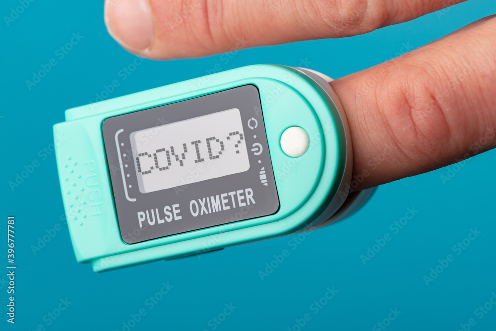 Finger in the blood oxygen meter. Oximeter shows 