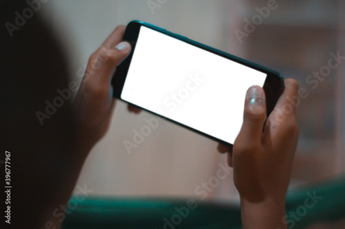 a little boy holding a smartphone