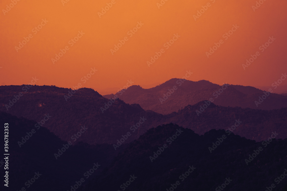 Silhouette of mountains, golden sky. Retro filter effects