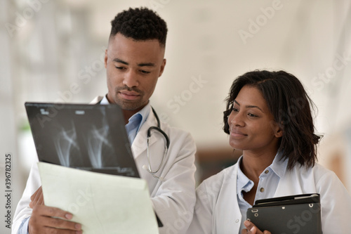 Radiologist showing X-ray to doctor photo