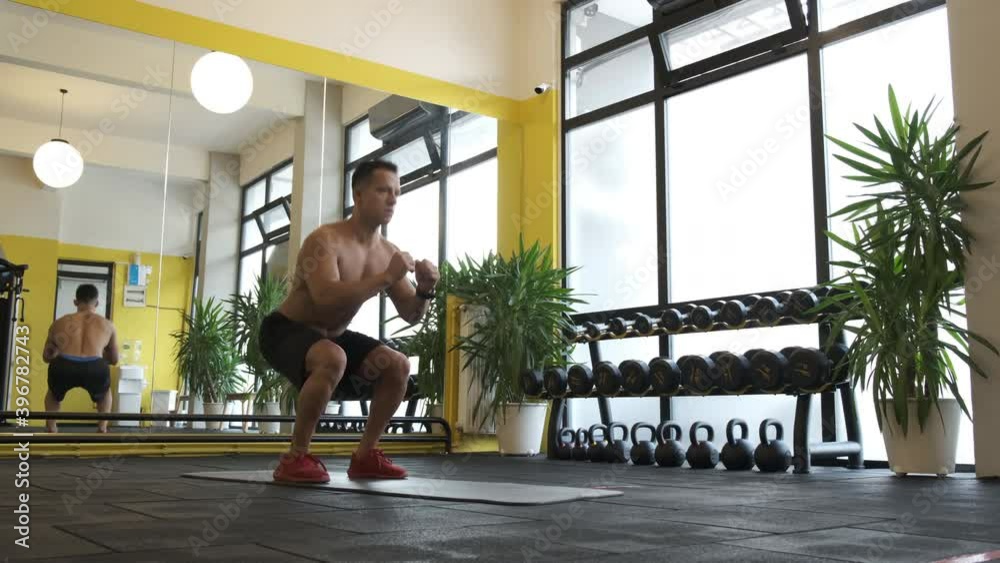 Man doing squat training. Healthy man with muscle in sportswear doing squat at gym. fitness workout. 4K Video Man doing squat training. Healthy man with muscle in sportswear doing squat at gym. fitness workout. 4K Video