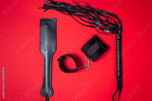 Fotografie BDSM accessories on a red background