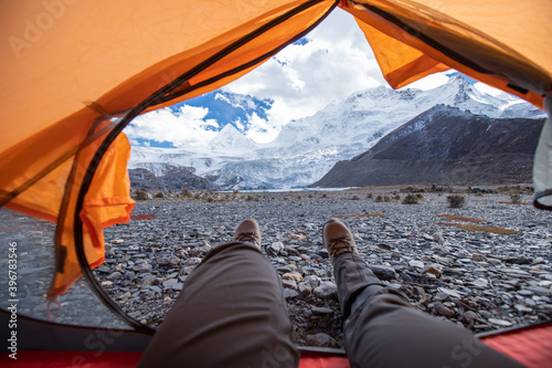 Hiker enjoy the beautiful landscape in tent