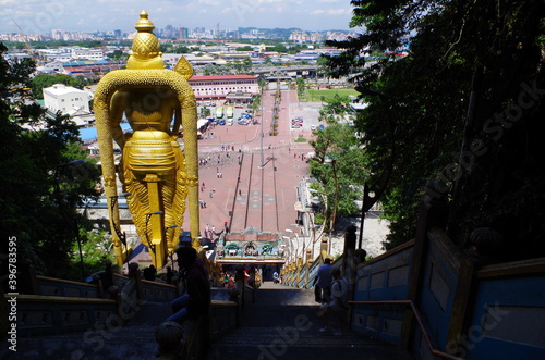 Photography Big Buddha statue in front of the historical and religious temple of Batu Caves in Malaysia, near the capital city Kuala Lumpur