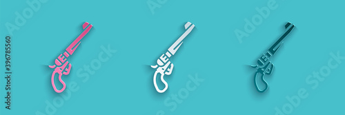 Paper cut Revolver gun icon isolated on blue background. Paper art style. Vector.