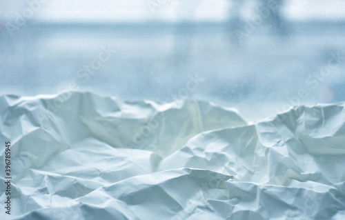  Crumpled paper on the background of a winter window.Abstract background.