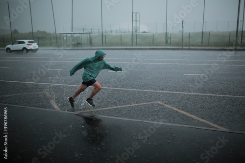man runs in the rain
