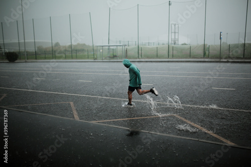 man runs in the rain