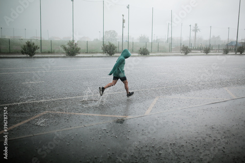 man runs in the rain
