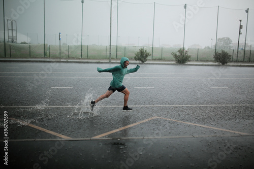 man runs in the rain