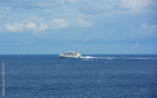 The speed ferry leaving coast. Ferry departure.Boat isolated in the sea background. Travel concept