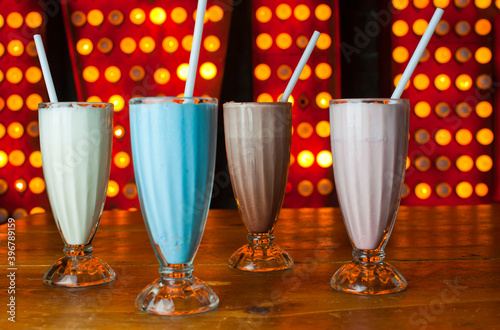 Milkshakes or Fruit smoothies. Classic America favorite: chocolate, vanilla or strawberry ice cream, milk, fruits and ice blended and served in milk shake glasses. Traditional diner drink.