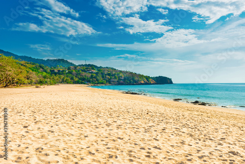 Tropical beach with white sand and green mountain near blue sea in Koh Lanta island  Thailand