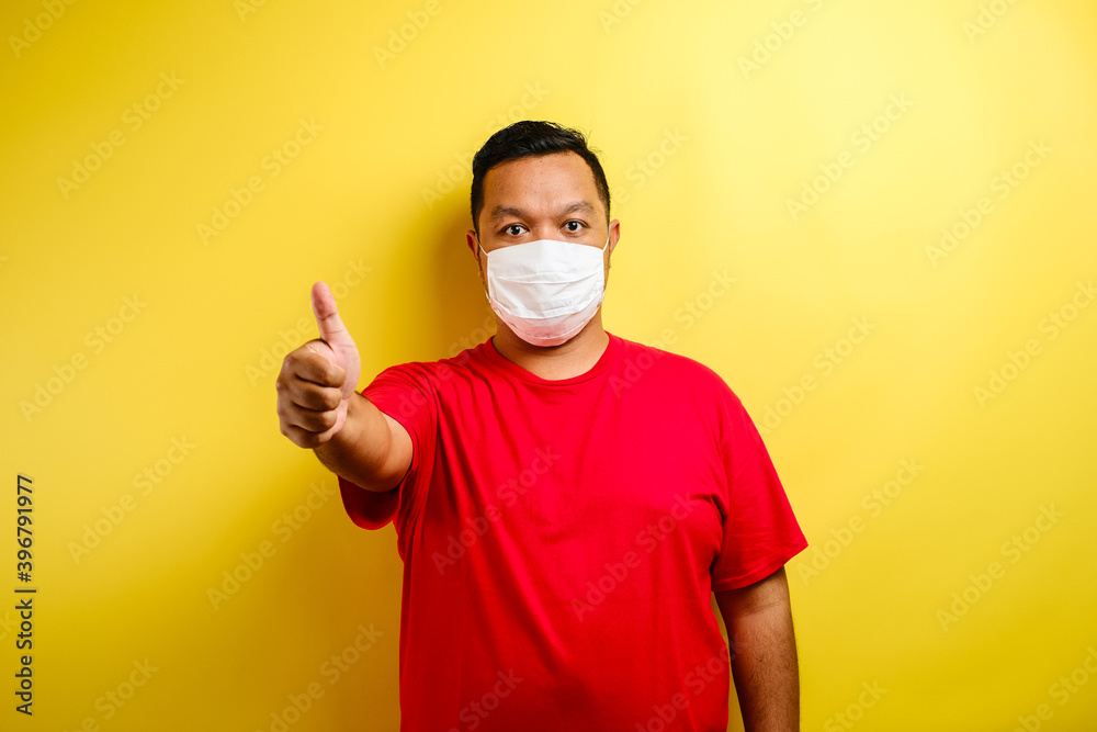 Asian man thumb up and wearing masks to prevent the spread of Corona virus