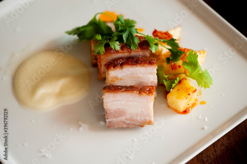 Pork belly. Pork seasoned with cracked black pepper and served with classic steakhouse side dishes  asparagus and mashed potatoes. Classic Japanese izakaya fine dining entree.