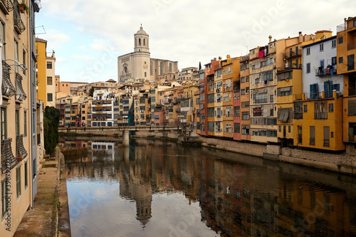 View of the river Onyar and the castle in the city of Girona,.colorful buildings in the historic city center at daytime. Spain. © Dinara Belozerova