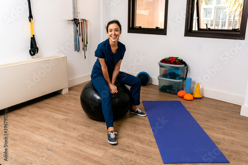 Woman physiotherapist in a Fitness Ball photo