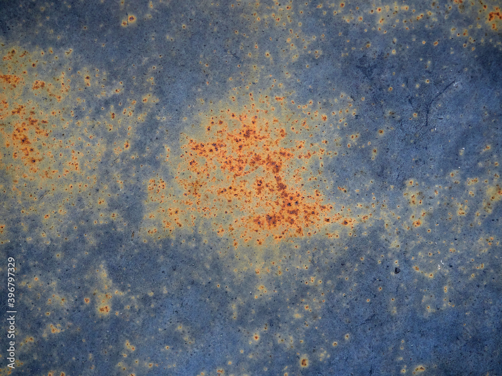 Rust.Old blue painted wall with rust spots.Textured rusty metal background. Rust stains through the cracked blue paint. Rust.Old blue painted wall with rust spots.Textured rusty metal background. Rust stains through the cracked blue paint.