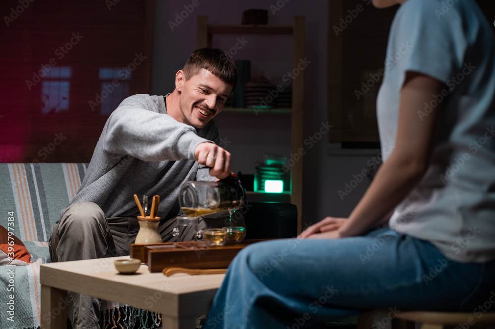 Date in an intimate setting of a tea house. A man and a woman drink fragrant tea together. Mysterious oriental tea ceremony Date in an intimate setting of a tea house. A man and a woman drink fragrant tea together. Mysterious oriental tea ceremony