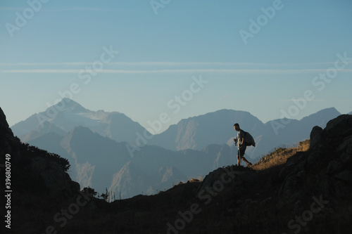 man with hiking poles in the mountains