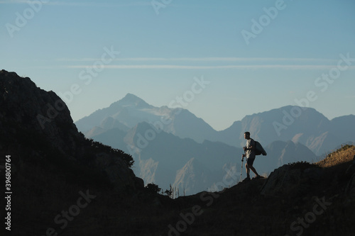 man with hiking poles in the mountains
