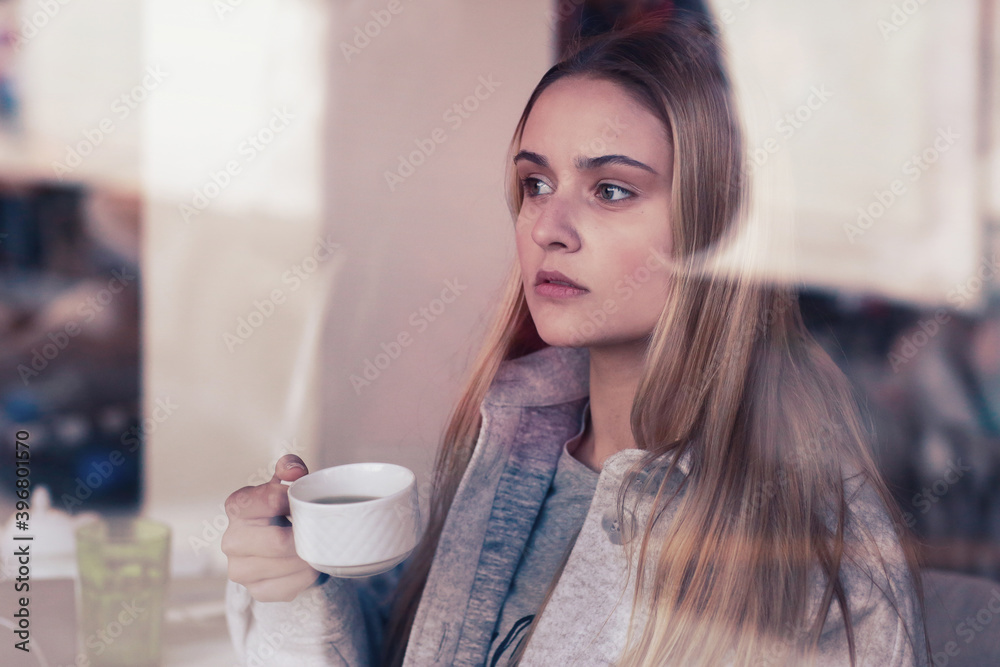  blond long hair beautiful girl close up portrait through the cafe window