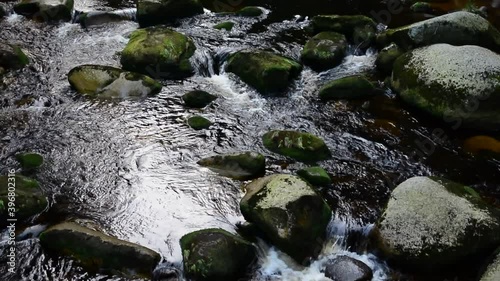 Flowing wild river between boulders.