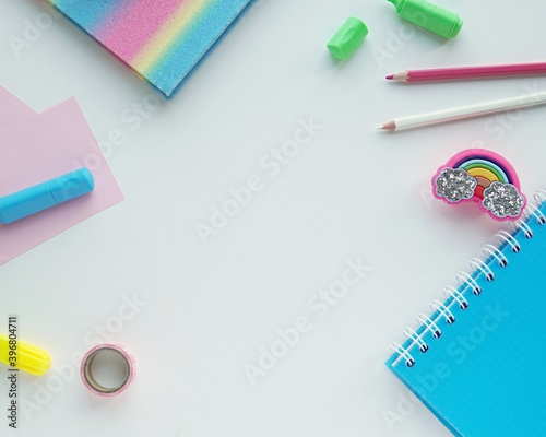 Colorful rainbow desk mockup, creative school supplies flat lay with space for text or product.