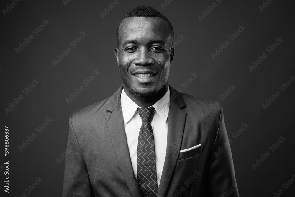 Studio shot of young African businessman against gray background Studio shot of young African businessman against gray background