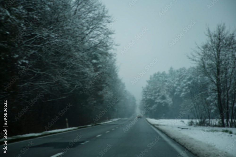 Fototapeta premium dark blurred winter road during snowstorm