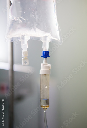 Fluid running from a drip in a hospital to be administered to a patient photo