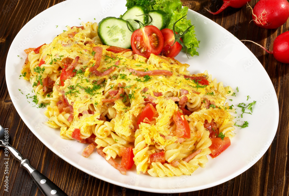 Cheesy Noodle Omelette with Tomato and Bacon on wooden Background Cheesy Noodle Omelette with Tomato and Bacon on wooden Background