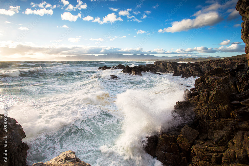 Wide Angle view of huge waves crashing in the cliffs of De Kelders of the coast of Gansbaai in South Africa Wide Angle view of huge waves crashing in the cliffs of De Kelders of the coast of Gansbaai in South Africa