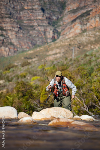 Tableau sur toile A Fly Fisherman casting to a Trout on a small Freestone stream in the Western Ca