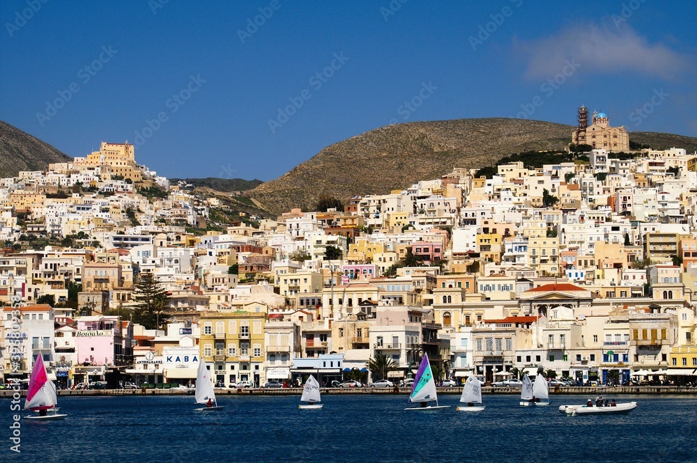 View of sailing boats with the town of Hermoupoli in the background, Syros island, Greece, April 9 2006.