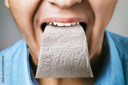 A person has toilet paper instead of a tongue. Concept on the topic of sycophancing.