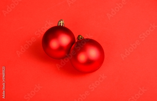 Red background with red Christmas balls. Christmas background, copy space