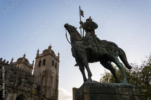 Warrior statue and cathedral of Porto in the background. V  mara Peres warrior. Blue sky. Porto