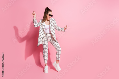 Full length photo of young crazy positive smile woman have fun enjoy music dance wear trousers isolated over pastel color background