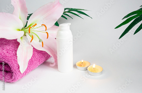 Face and body care  concept with Spa kit  towel  candles  cream on a white background. copy space
