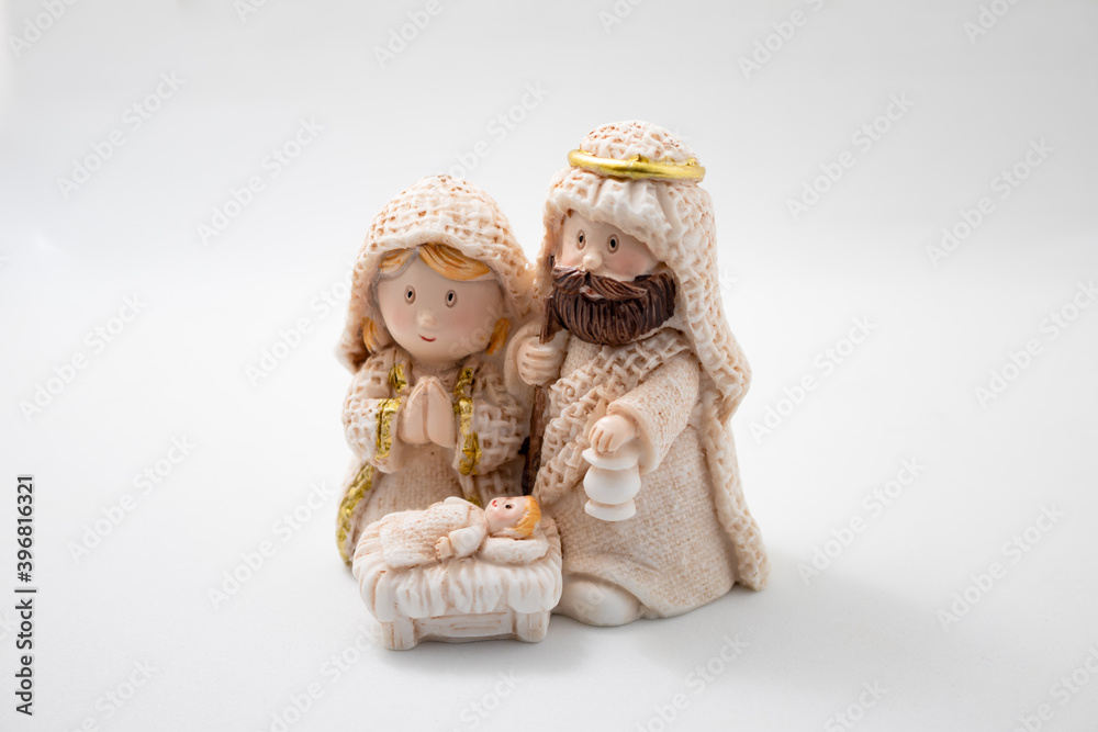 Representation of a Christmas nativity scene with the figures of baby Jesus, Mary and Joseph on a white Background. Christmas concept. Representation of a Christmas nativity scene with the figures of baby Jesus, Mary and Joseph on a white Background. Christmas concept.