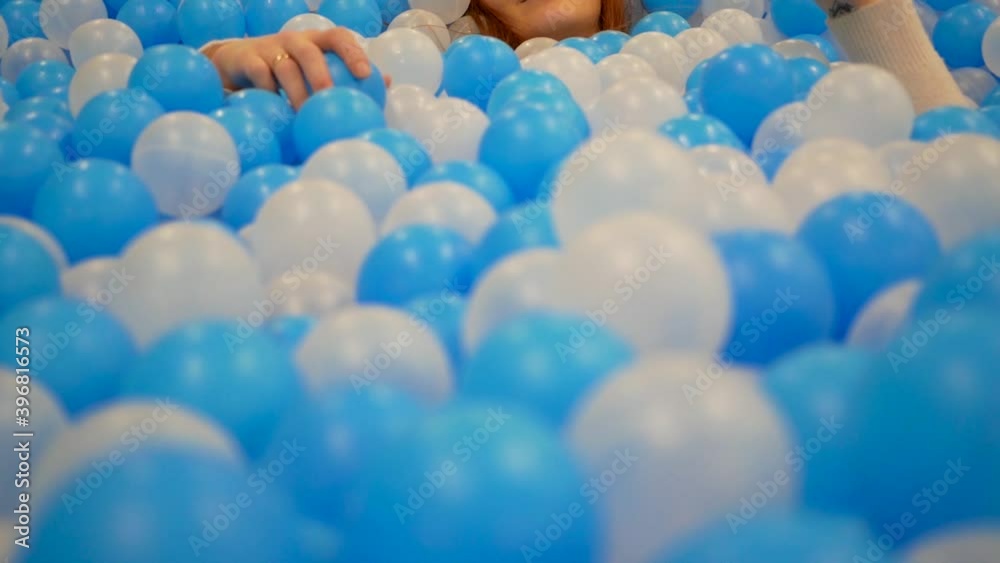 young red-haired girl lies in baby balls young red-haired girl lies in baby balls