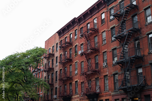 Row of Old Brick Apartment Buildings with Fire Escapes in Hell's Kitchen of New York City