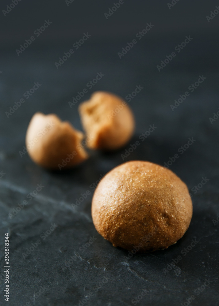 Obraz premium Soft small bun made from rye flour on gray background