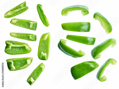 Cut slices of green  sweet bell pepper isolated on white background. Top view.