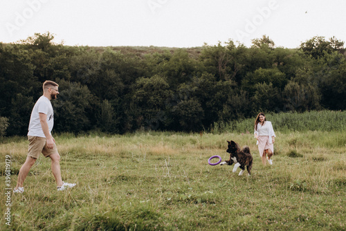 American Akita dog for a walk with a guy and a girl © omelnickiy